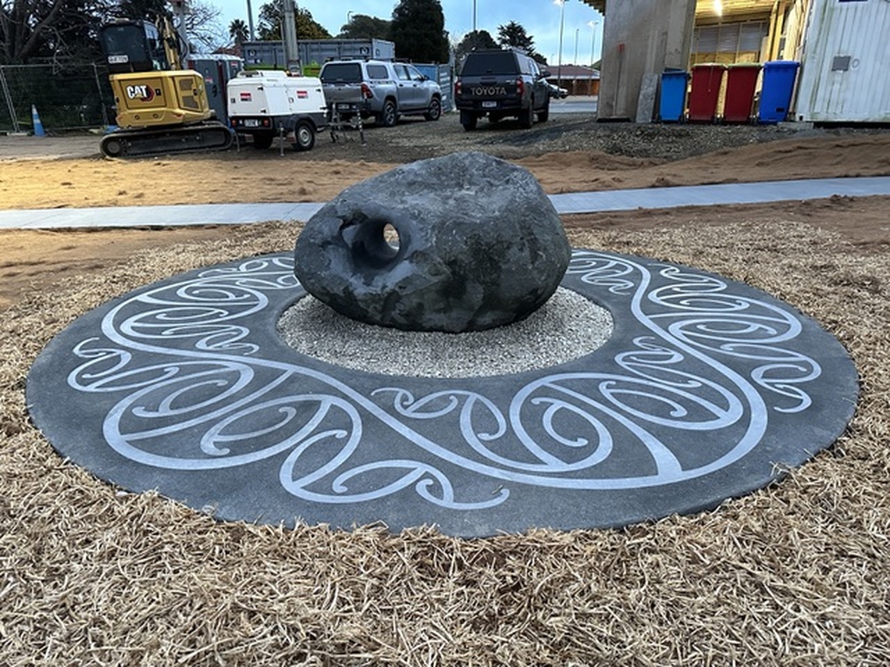 The hand behind the stone