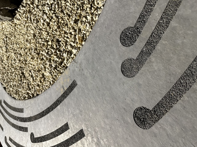 Close detail of a radial carved spiral plate surface