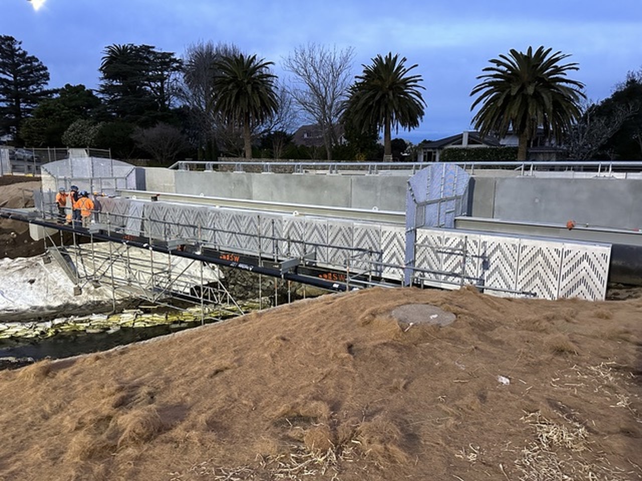 Public bridge and walkway installation with perforated-metal panels