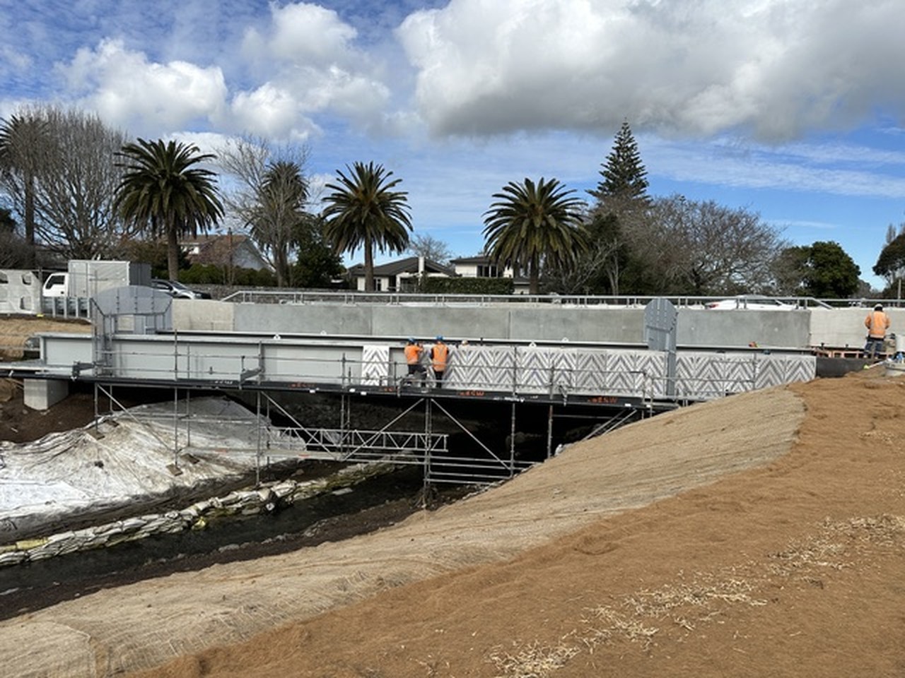 Public bridge and walkway installation among palms